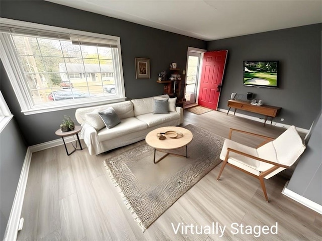 6133 Walrond Ave, Kansas City, MO 64130 - living room featuring a healthy amount of sunlight, baseboards, and wood finished floors
