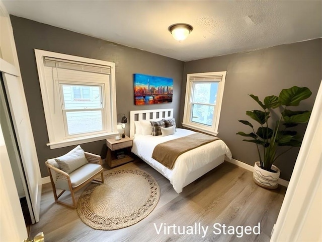 6133 Walrond Ave, Kansas City, MO 64130 - bedroom with baseboards and wood finished floors
