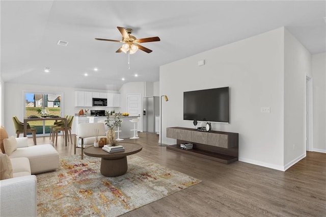 living room with hardwood / wood-style flooring and ceiling fan