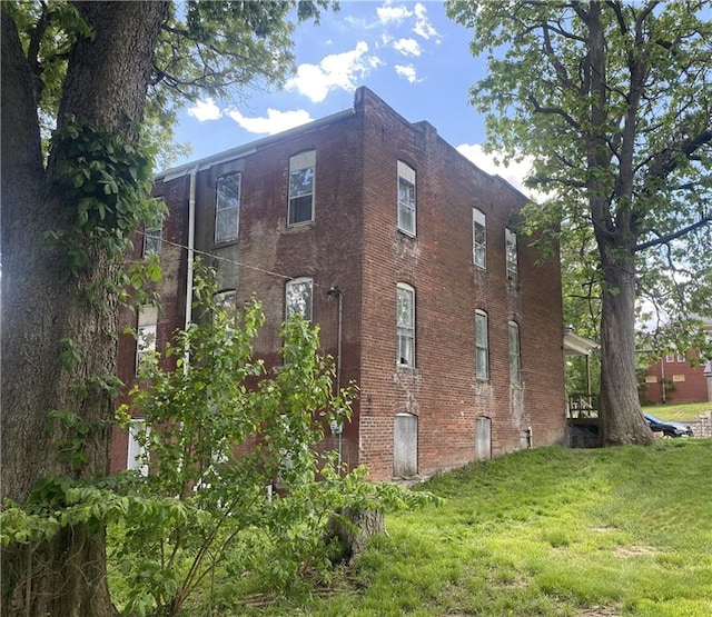 view of side of home featuring a yard