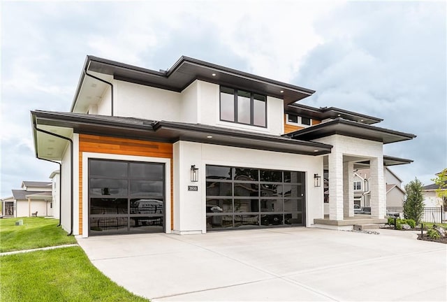 view of front of home featuring a front yard and a garage