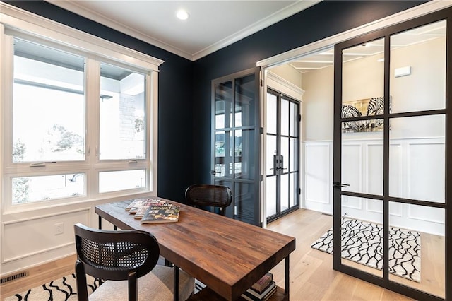 office area featuring crown molding, light hardwood / wood-style floors, and french doors