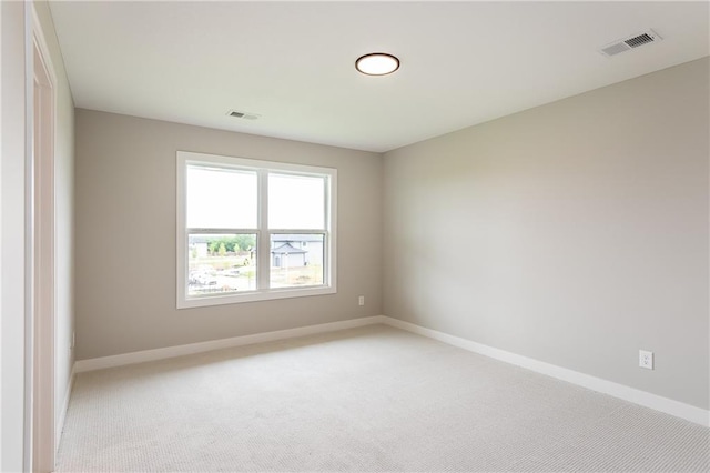 spare room with light colored carpet