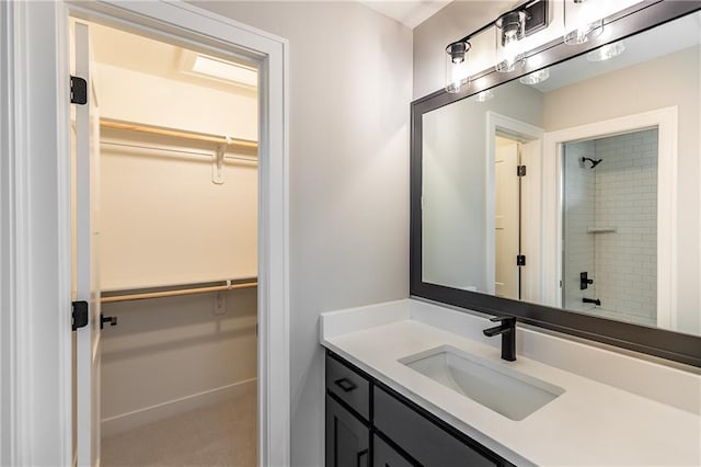 bathroom with vanity and tiled shower