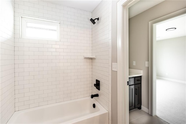 bathroom featuring vanity, tiled shower / bath combo, and tile patterned flooring