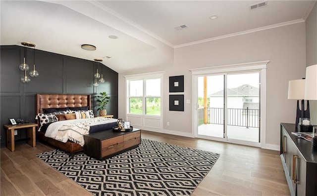 bedroom with ornamental molding, multiple windows, access to outside, and hardwood / wood-style flooring