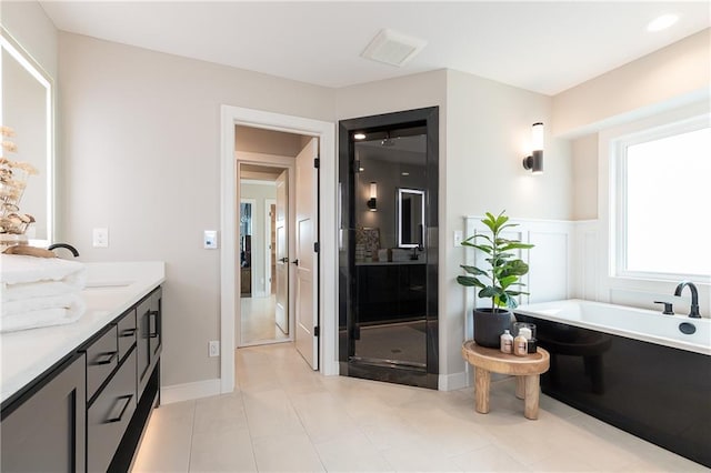 bathroom with vanity, independent shower and bath, and tile patterned floors