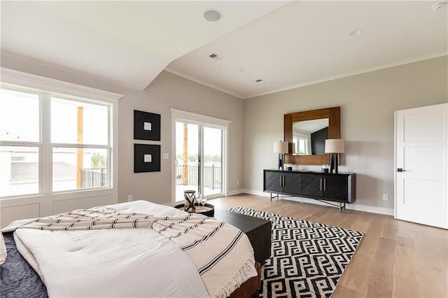 bedroom with light hardwood / wood-style flooring, ornamental molding, and access to exterior