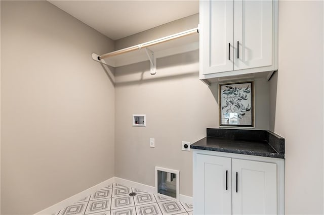 washroom with electric dryer hookup, washer hookup, and cabinets