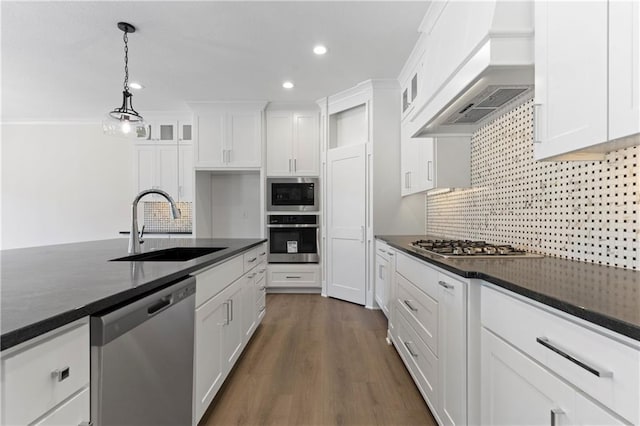 kitchen featuring premium range hood, dark hardwood / wood-style floors, stainless steel appliances, and white cabinetry