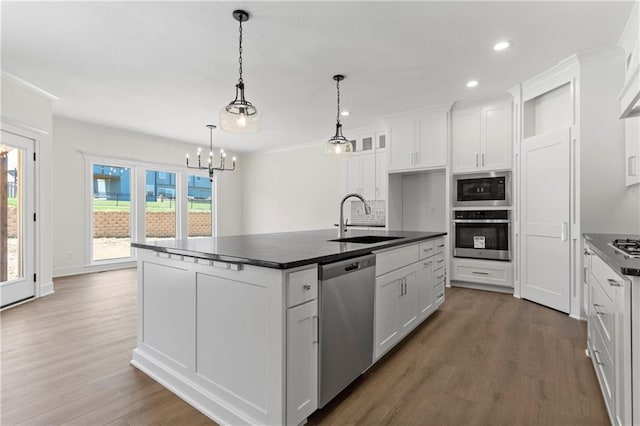 kitchen featuring sink, white cabinetry, stainless steel appliances, and hardwood / wood-style flooring