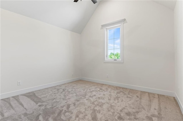 unfurnished room featuring carpet flooring, ceiling fan, and vaulted ceiling