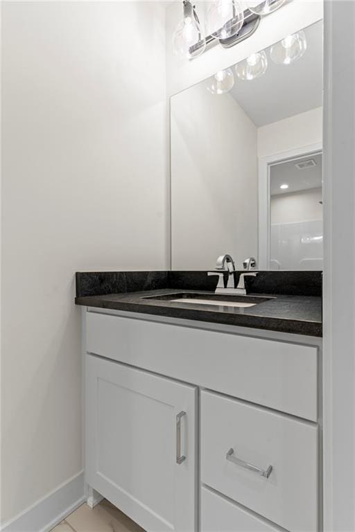 bathroom with tile floors and vanity