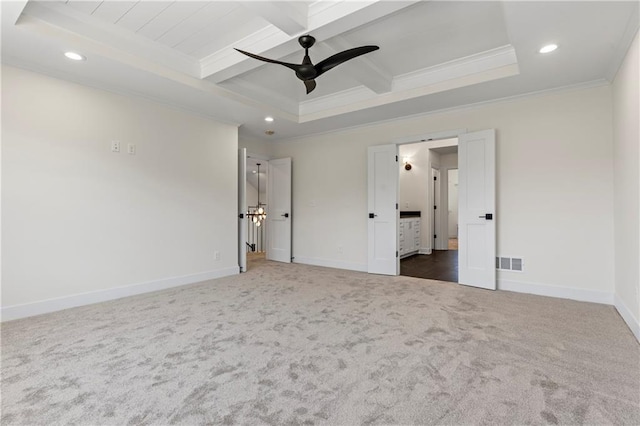 unfurnished bedroom with beamed ceiling, ornamental molding, dark colored carpet, coffered ceiling, and ceiling fan