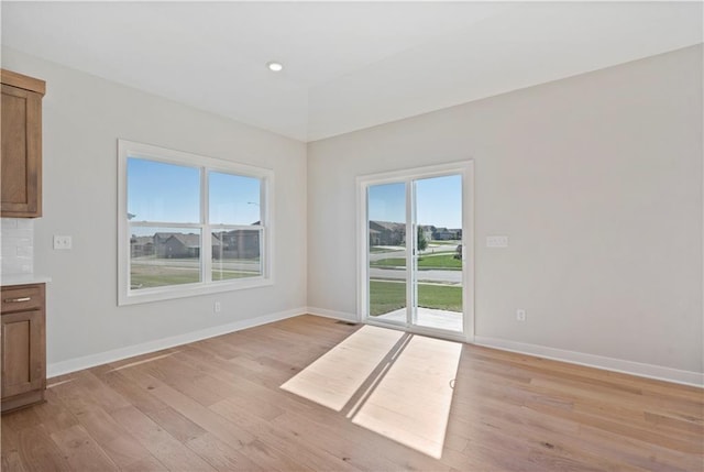 unfurnished dining area with light wood-type flooring