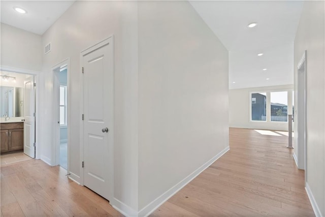 hall with light hardwood / wood-style floors