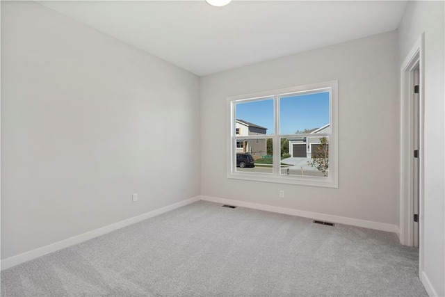 unfurnished room with light carpet