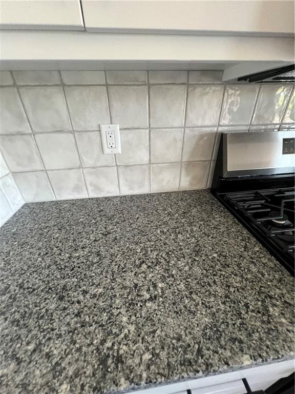 room details featuring black range oven and dark stone counters