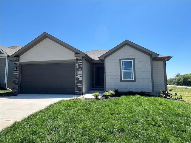 single story home with a front yard and a garage