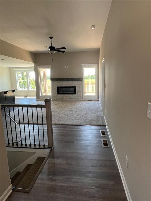 carpeted living room featuring ceiling fan