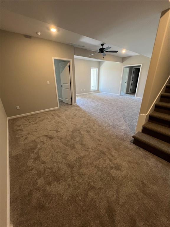 unfurnished room featuring ceiling fan and carpet