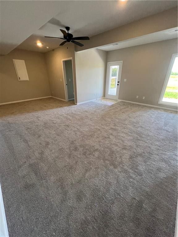 carpeted spare room with ceiling fan