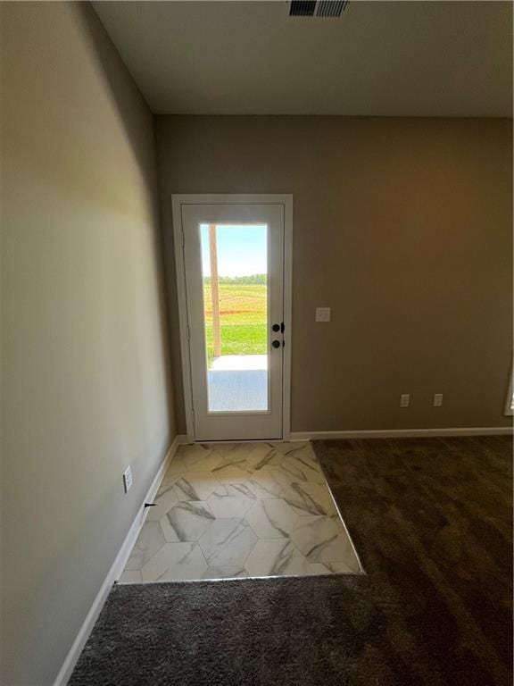 doorway with light carpet