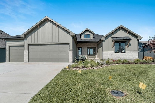 view of front of house with a garage and a front lawn