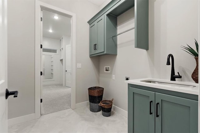 laundry room featuring hookup for an electric dryer, light colored carpet, washer hookup, cabinets, and sink