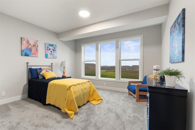 bedroom featuring multiple windows and light carpet