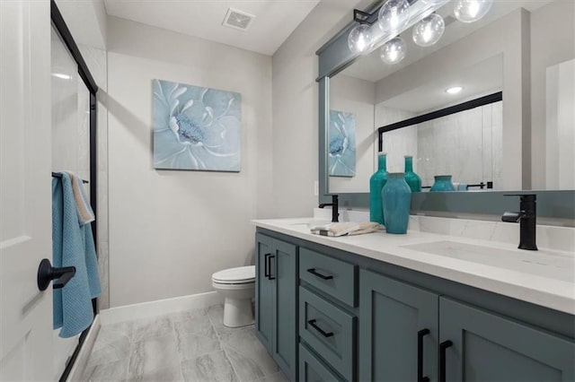 bathroom featuring walk in shower, vanity, and toilet