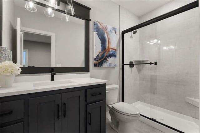 bathroom featuring an enclosed shower, toilet, vanity, and a notable chandelier