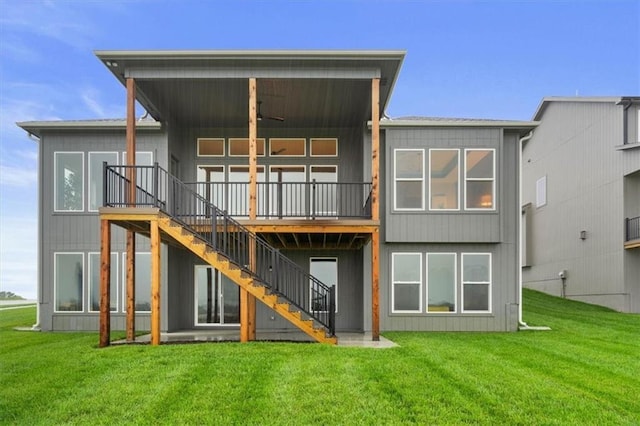 back of property with ceiling fan and a lawn