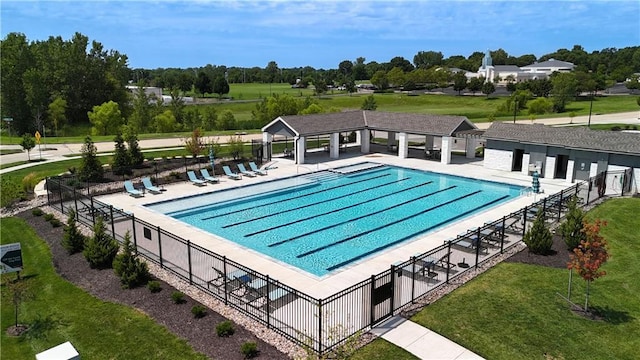 view of pool featuring a lawn and a patio