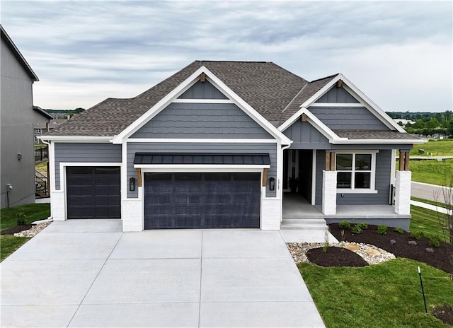 view of front of property with a porch, an attached garage, driveway, and board and batten siding