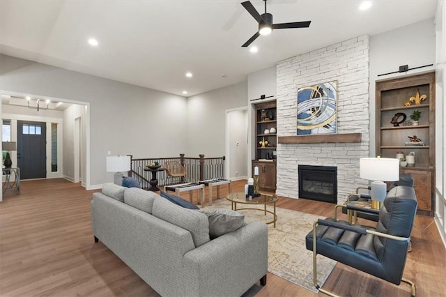 1717 SW Arbormill Ter, Lees Summit, MO 64082 - living room featuring ceiling fan, wood finished floors, baseboards, a stone fireplace, and recessed lighting