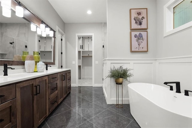 1717 SW Arbormill Ter, Lees Summit, MO 64082 - bathroom featuring a stall shower, a soaking tub, double vanity, a decorative wall, and marble finish flooring