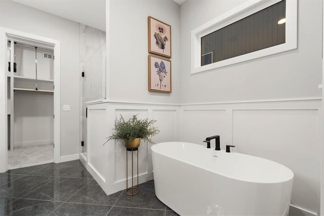 1717 SW Arbormill Ter, Lees Summit, MO 64082 - bathroom featuring a decorative wall, a freestanding bath, wainscoting, and marble finish floors