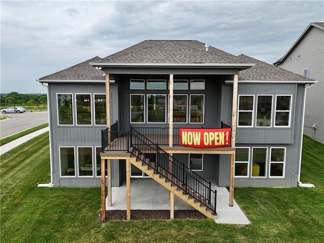 1717 SW Arbormill Ter, Lees Summit, MO 64082 - rear view of house with a shingled roof, a lawn, and stairs