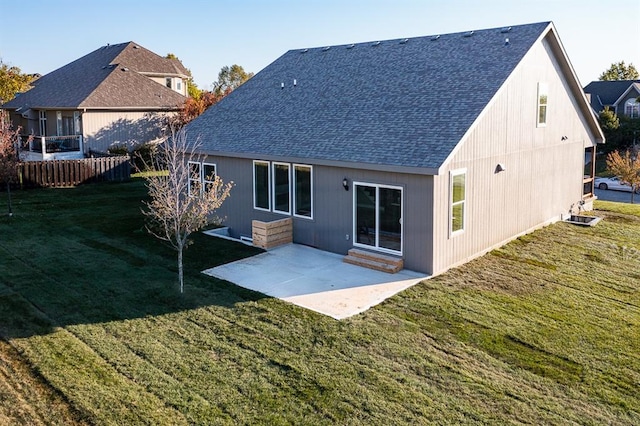 rear view of house featuring a patio area and a lawn