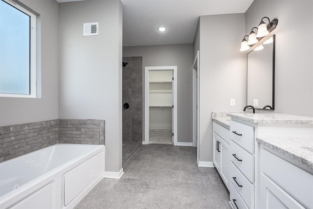 bathroom with vanity and independent shower and bath