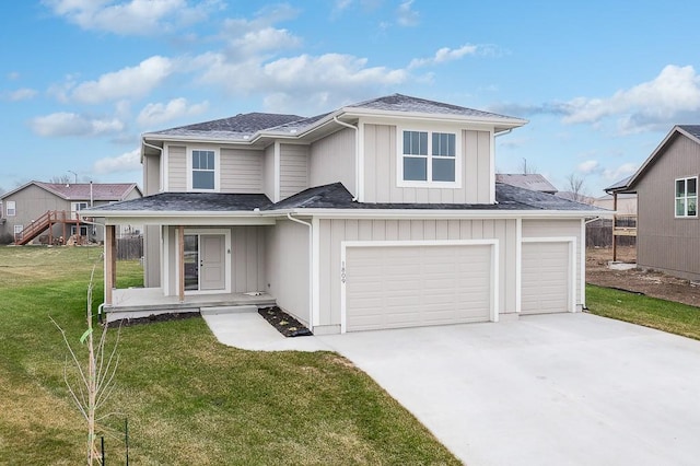 view of front of property featuring a front lawn, covered porch, and a garage