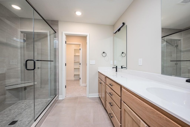 bathroom featuring tile patterned floors, vanity, and an enclosed shower