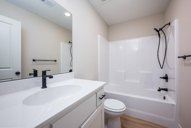 full bathroom featuring hardwood / wood-style floors, vanity, toilet, and shower / washtub combination