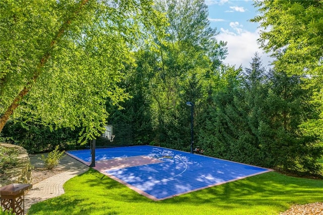 view of sport court featuring basketball court and a lawn