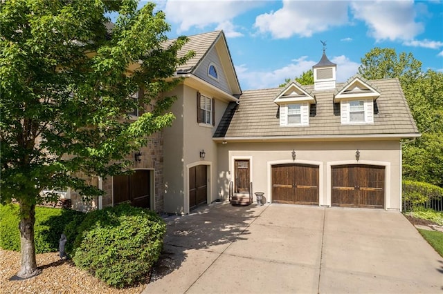 view of front of property featuring a garage, driveway, and stucco siding