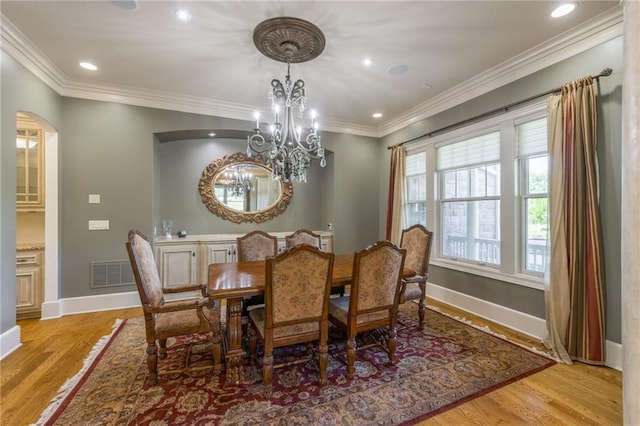 dining area featuring ornamental molding, baseboards, visible vents, and light wood finished floors