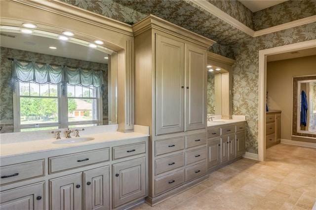 bathroom with wallpapered walls, visible vents, baseboards, and vanity