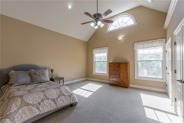 carpeted bedroom featuring ceiling fan, high vaulted ceiling, multiple windows, and baseboards