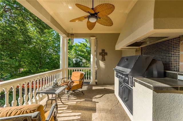 view of patio featuring ceiling fan, exterior kitchen, and grilling area